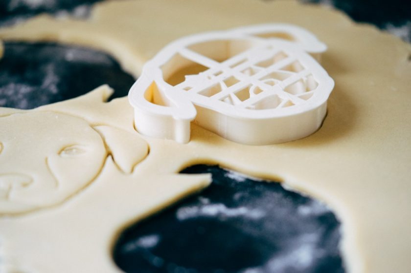 3d printed dog-face cookie cutter sitting on top of dough