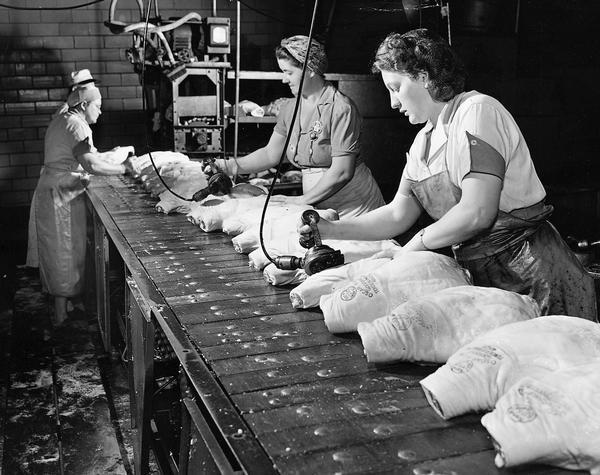 Women on Assembly Line Stamping Hams